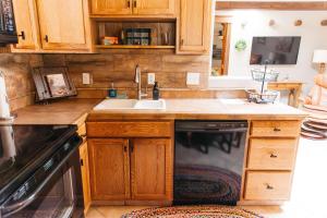 a kitchen with wooden cabinets and a sink at Calle Condo in Green Valley +17 photos