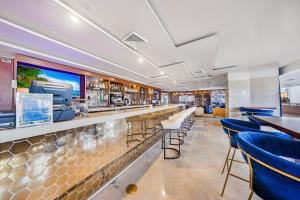 a bar in a restaurant with blue bar stools at Oceanview Apt Marenas Resort, Direct Beach Access! in Sunny Isles Beach