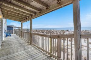 a wooden porch with a view of the beach at Divine Intervention by Oak Island Accommodations in Oak Island