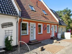 a orange and white house with a tiled roof at Delphin in Pruchten