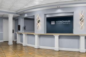 a lobby with a counter with a sign on the wall at Club Wyndham Sea Gardens in Pompano Beach