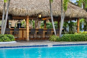 a resort with a swimming pool with chairs and a bar at Club Wyndham Sea Gardens in Pompano Beach