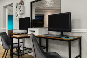 a desk with a computer monitor and a printer at Club Wyndham Sea Gardens in Pompano Beach +46 photos