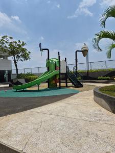 a playground with a slide in a park at Cozy 1BR UResidence 2 by REJA Essentials in Klapadua