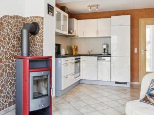 a kitchen with a stove in the middle of a room at Delphin in Pruchten +12 photos