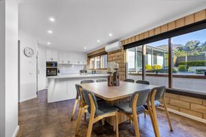 a kitchen and dining room with a table and chairs at Route 86 Bright in Bright