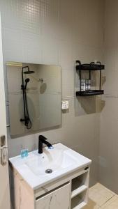 a bathroom with a sink and a mirror at شقق مرفا in Hail +11 photos