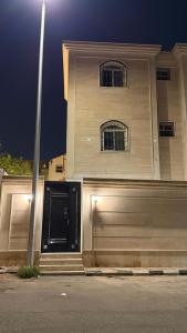 a building with a garage and a pole in front of it at شقق مرفا in Hail