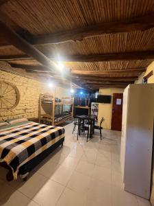a bedroom with a bed and a table in a room at El Farolo in Tilcara