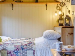 a bedroom with a bed with a quilt on it at 1 Bed in Lydney oc-85862 in Bream