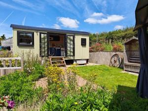 a small yellow tiny house in a garden at 1 Bed in Lydney oc-85862 in Bream