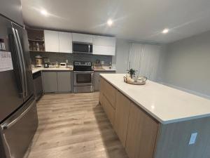 a kitchen with stainless steel appliances and white cabinets at Cozy Rooms in Decatur in Decatur +13 photos