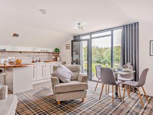 a kitchen and living room with a chair and a table at 2 Bed in Sheffield oc-92978 in Langsett