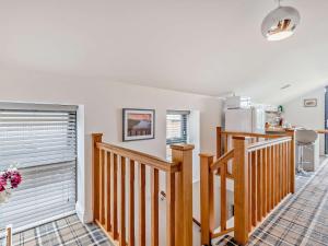 a living room with a staircase and a kitchen at 2 Bed in Sheffield oc-92978 in Langsett +9 photos