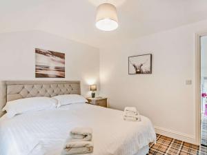 a bedroom with a large white bed with towels on it at 2 Bed in Sheffield oc-92978 in Langsett