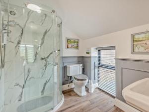 a bathroom with a shower and a toilet and a sink at 2 Bed in Sheffield oc-92978 in Langsett