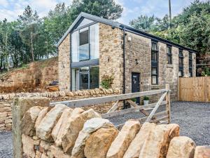 a stone house with a stone wall at 2 Bed in Sheffield oc-92978 in Langsett