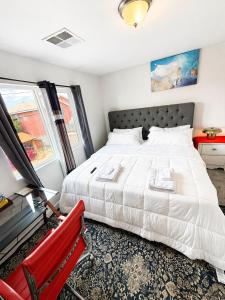 a bedroom with a bed and a red chair at Penn Signature Airport Short Term Rental PHX in Phoenix