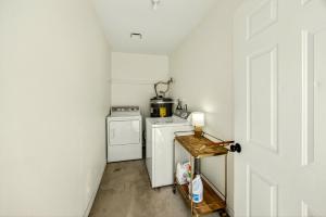 a small laundry room with a washer and dryer at Basecamp GP- Private Unit in Quiet Duplex Near Downtown in Grants Pass