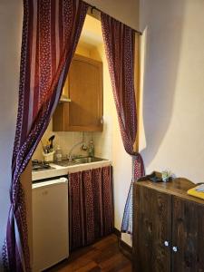 a kitchen with curtains and a sink and a counter at La Luna nel Borgo in Spello