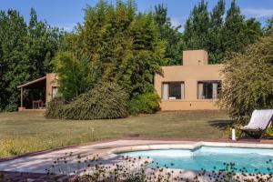a house with a swimming pool in front of it at Quita penas in Los Reartes