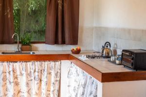 a kitchen with a counter top with a toaster oven at Quita penas in Los Reartes +1 photo