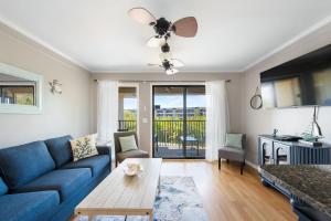 a living room with a blue couch and a table at New Listing - Spring Discounts Beach View Condo in Hilton Head Island