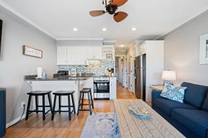 a kitchen and living room with a blue couch at New Listing - Spring Discounts Beach View Condo in Hilton Head Island