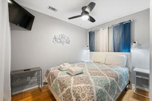 a bedroom with a bed and a flat screen tv at New Listing - Spring Discounts Beach View Condo in Hilton Head Island +29 photos