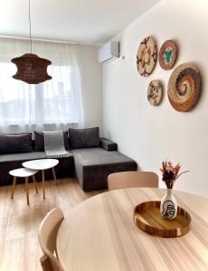 a living room with a table and a couch at Upendo Apartment in Vrnjačka Banja