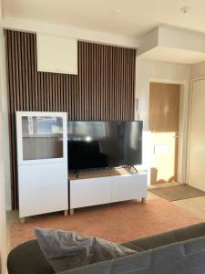 a living room with a large flat screen tv at Apartments Maaherrankatu in Kuopio