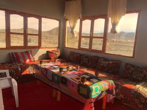 a living room with a couch and a table at Auberge High Atlas B&B in Alemrhou