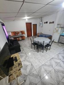 a room with a table and chairs and a tv at Cabañas El Monchito in Juana Koslay  +3 photos