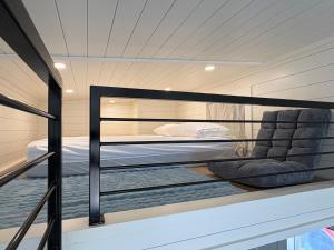 a room with a bunk bed on a boat at Oceanfront Tiny Retreat in Holden Beach