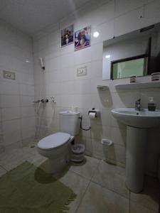 a bathroom with a toilet and a sink at Providence Guesthouse and Catering Services in Abidjan +15 photos