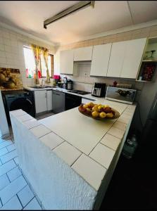 a kitchen with a bowl of fruit on a counter at Premium Executive Room in Sandton