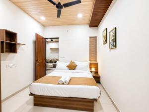 a bedroom with a large bed in a room at Hotel Aventus Suites Indore in Indore