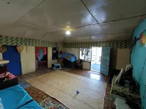 a living room with a couch and a living room with a room at Phantom rock view homestay in Namara
