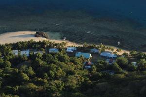 an aerial view of a beach with houses and trees at Phantom rock view homestay in Namara