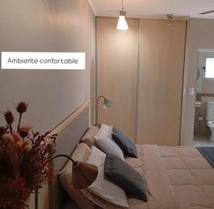 a bedroom with a bed with pillows on it at El DESCANSO HOSPEDAJE in Resistencia +2 photos