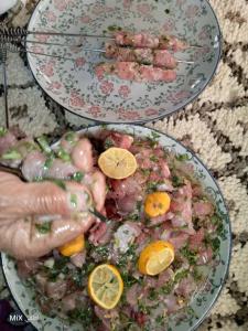 two plates of food with meat and orange slices at Auberge High Atlas B&B in Alemrhou +20 photos