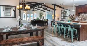 a kitchen and living room with wooden tables and chairs at 508 Clubhouse in Newport Beach