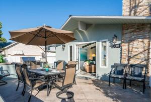 a table and chairs with an umbrella on a patio at 508 Clubhouse in Newport Beach