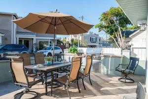 a table and chairs with an umbrella on a patio at 508 Clubhouse in Newport Beach