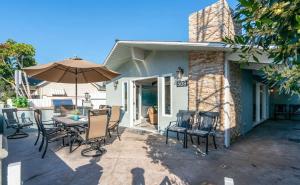 a patio with a table and chairs and an umbrella at 508 Clubhouse in Newport Beach +34 photos