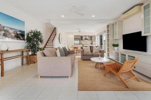 a living room with a couch and a table at Pet Friendly Modern Oasis with Private Pool in Noosaville