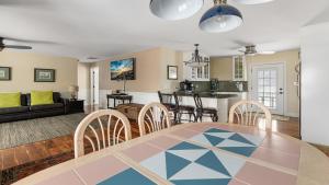 a dining room and living room with a table and chairs at Congress Cottage in Cape May