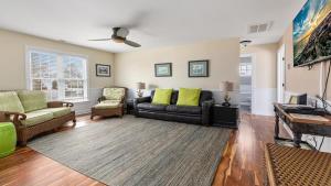 a living room with a couch and a table at Congress Cottage in Cape May