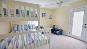 a bedroom with a white bunk bed and a window at Congress Cottage in Cape May