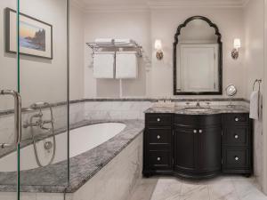 a bathroom with a tub and a sink and a mirror at Liora Estate in Healdsburg